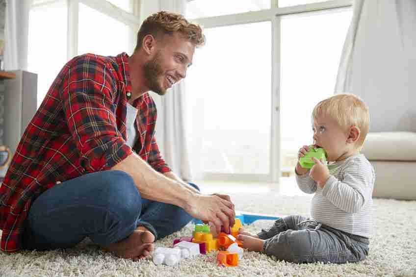 oung father and son playing together at home, close up