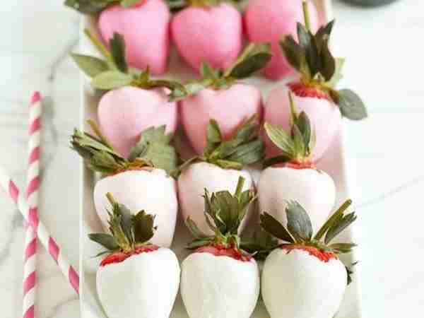 strawberries covered in white and pink yougurt that have been frozen