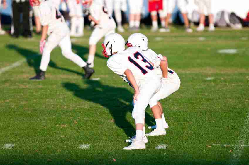 Quarterback during a game with his quarterback waiting for the snap.