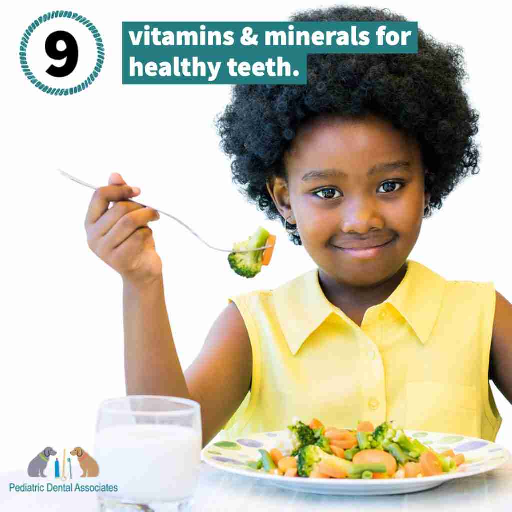 LIttle girl around 7 wearing a yellow sleeveless shirt with a plate of vegetables in front of her and a glass of milk. She has a fork with veggies on it.